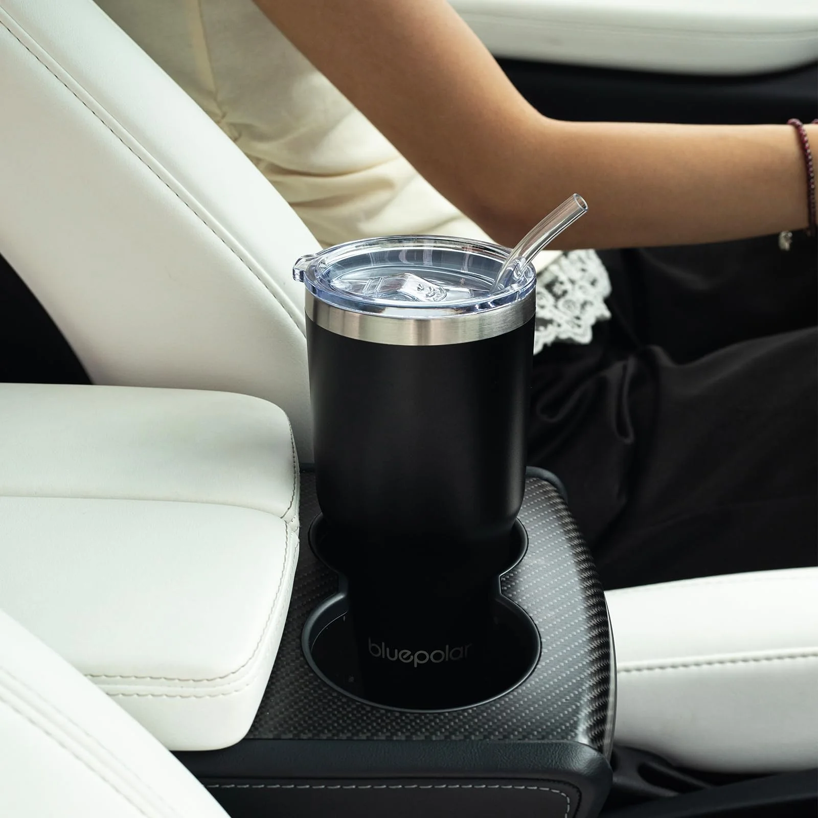 The 20 oz steel cup sitting in a car cup holder.