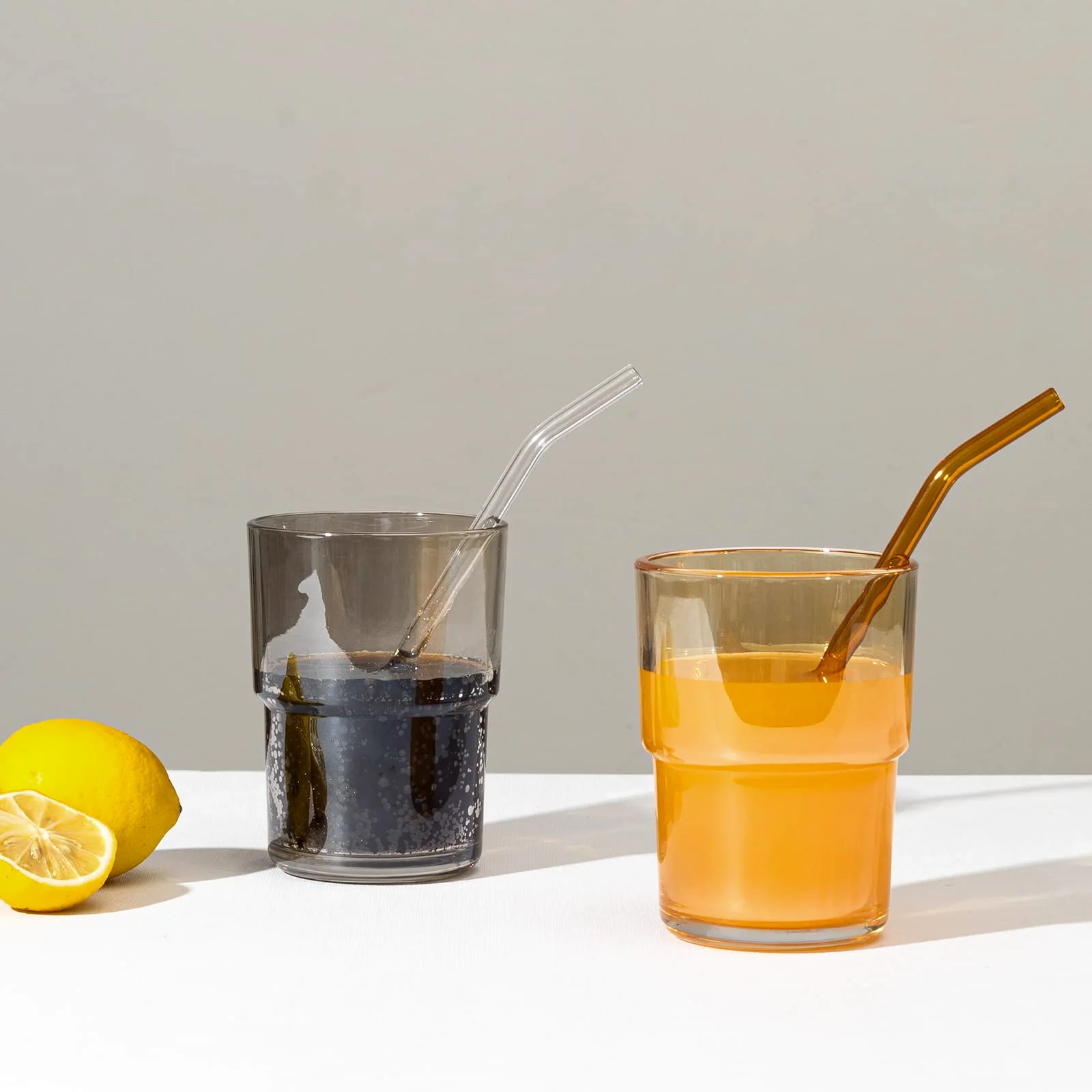 Glass straws standing in two glasses.